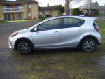 Side view of a 2019 Toyota Prius C hybrid car in excellent condition for sale.