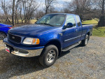 1998 Ford F150 XLT extended cab 4X4 in blue color with 79,412 miles, parked outdoors with some scratches and rust.