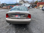 Rear view of a 2003 Ford Focus with a clean title, showing excellent condition and ready for immediate driving.